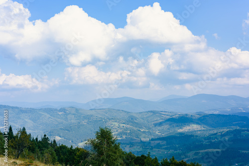 Carpathian Mountains in Summer. Beautiful nature landscape with mountains, trees and blue sky with clouds photo