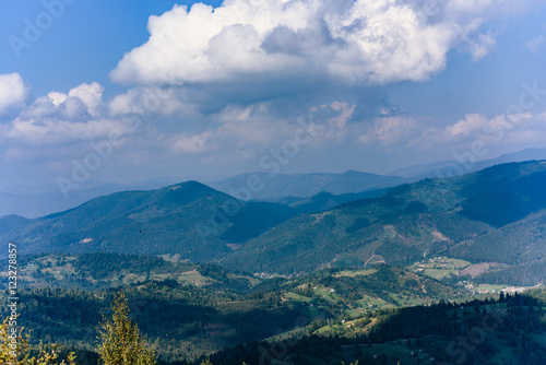 Carpathian Mountains in Summer. Beautiful nature landscape with mountains, trees and blue sky with clouds photo