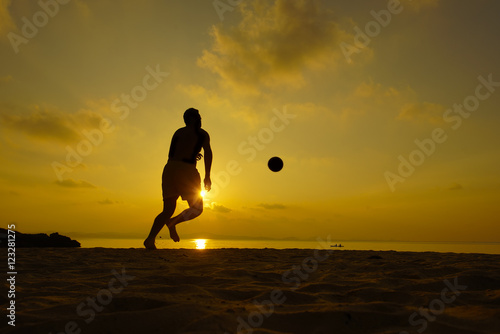 Silhouettes of footballers on the sunset sky. photo