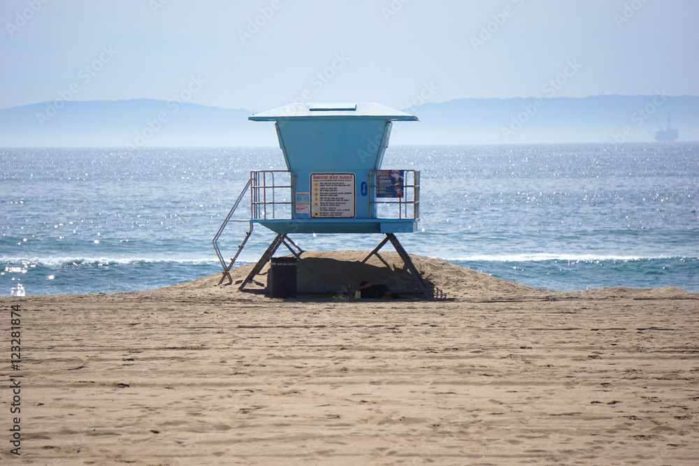 blue lifeguard stand on beach