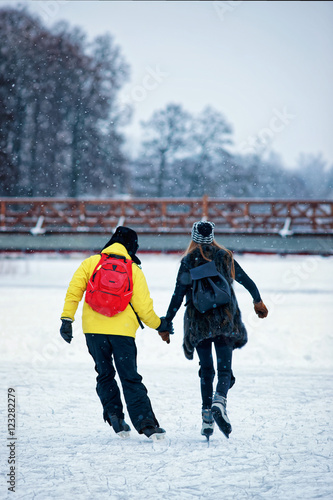 Girl and fellow ice skating in Trakai Lithuania