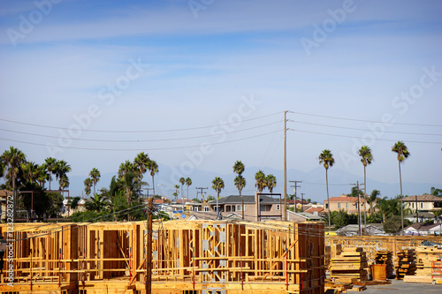 new construction in framing stage with palm trees in background