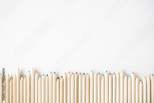 Color wooden pencils isolated on white background. Close up, flat lay