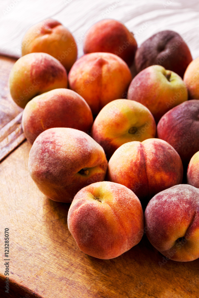 Sweet ripe peaches on a wooden table Sweet ripe peaches on a wooden table
