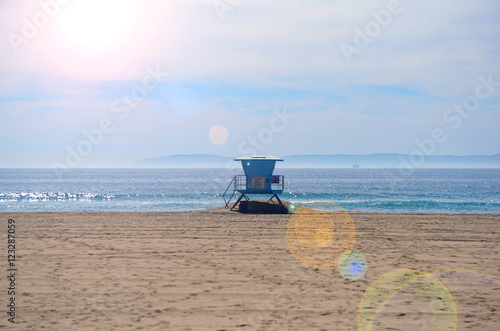 lifeguard tower on beach with bright sun flare