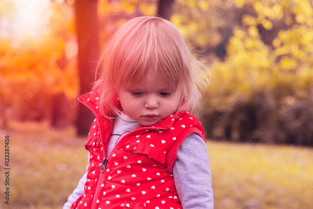 Toddler in the park on autumn day Toddler in the park on autumn day