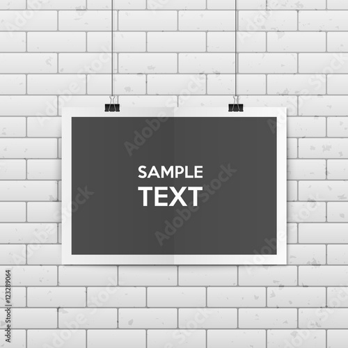 Sheet of folded paper hangs on the clamps.