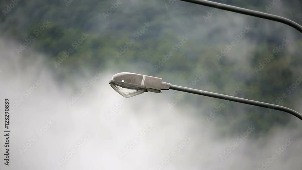 mist weather with lamppost on highway