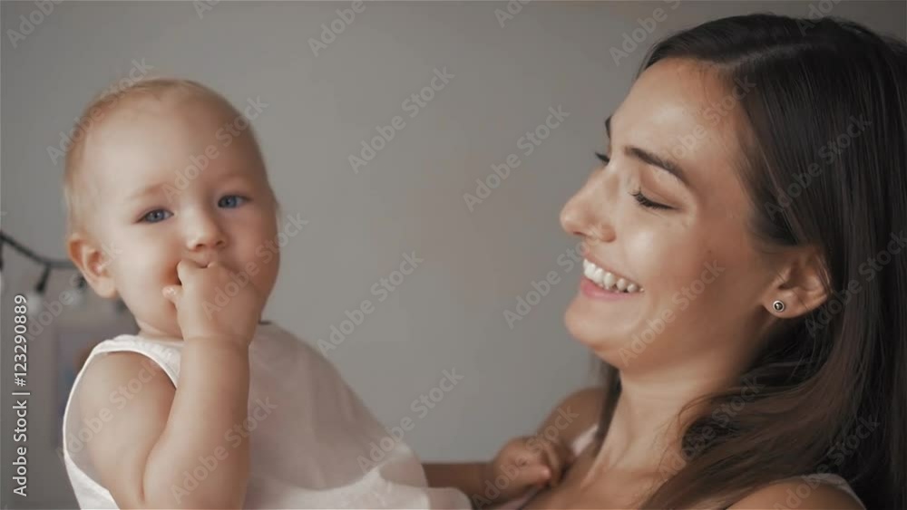 Happy cheerful family. Mother and baby kissing, laughing and hugging. Smile of mom and little child. Happy cheerful family. Mother and baby kissing, laughing and hugging. Smile of mom and little child.