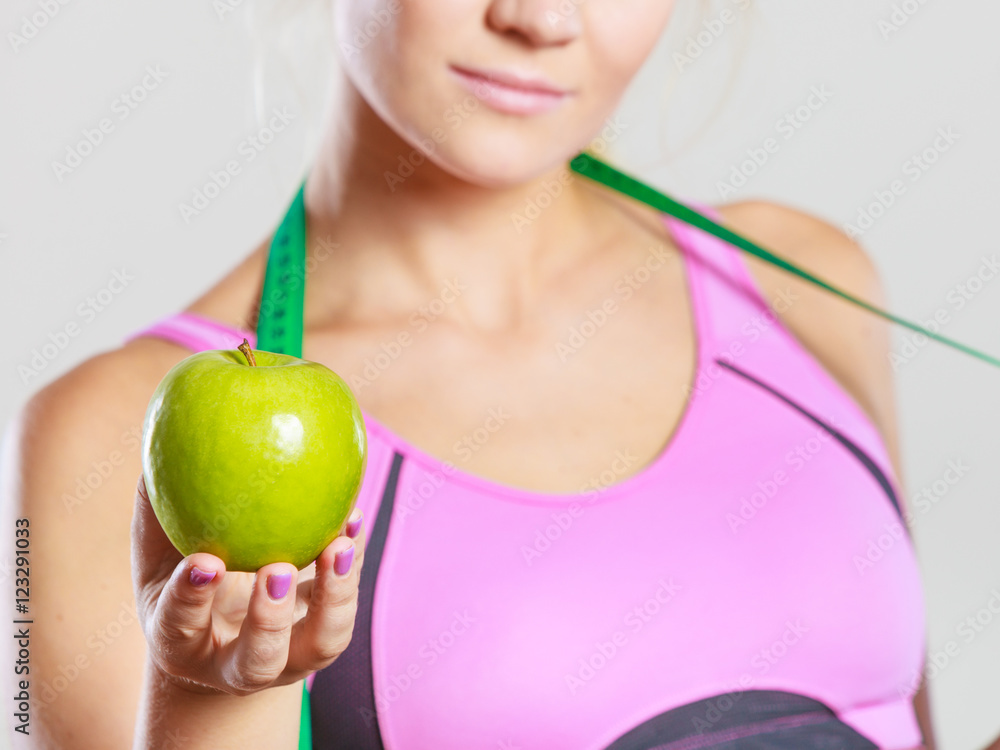 woman fit girl with measure tape and apple fruit woman fit girl with measure tape and apple fruit