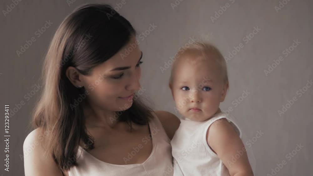 Young Happy Mother Holding her Newborn Child. Family at home. Beautiful smiling Mom and Happy Baby Together. Young Happy Mother Holding her Newborn Child. Family at home. Beautiful smiling Mom and Happy Baby Together.