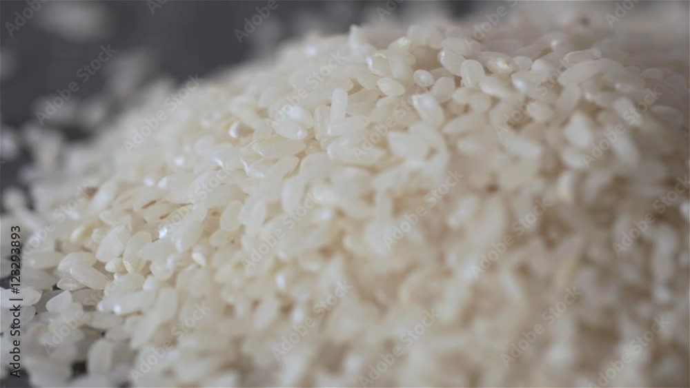 Close-up of dropping rice on craft black background. Super macro shot Close-up of dropping rice on craft black background. Super macro shot
