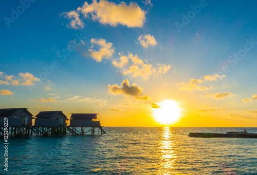 Beautiful sunset with water villas in tropical Maldives island