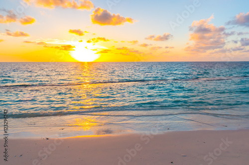 Beautiful sunset with sky over calm sea in tropical Maldives is