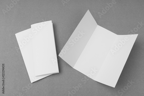 Trifold white template paper on gray background . © jannoon028