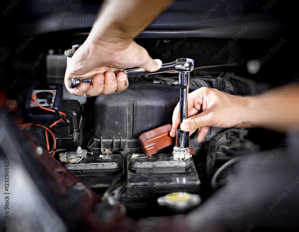 Hands of car mechanic with wrench in garage. Hands of car mechanic with wrench in garage.