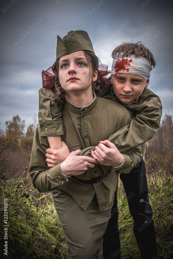 children in a military uniform. Historical reconstruction of the Great Patriotic War. Soviet troops. nurse saves the wounded soldier