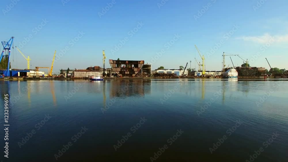 Flying Low Over Water Near Shipyard Construction Site Flying Low Over Water Near Shipyard Construction Site