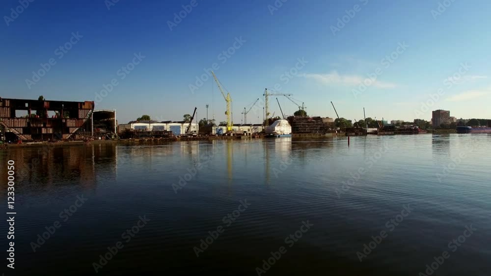 Flying Low Over Water Near Shipyard Construction Site Flying Low Over Water Near Shipyard Construction Site