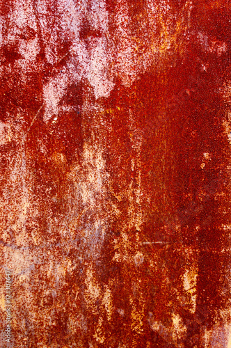 Background of old red wall of iron with peeled paint 
