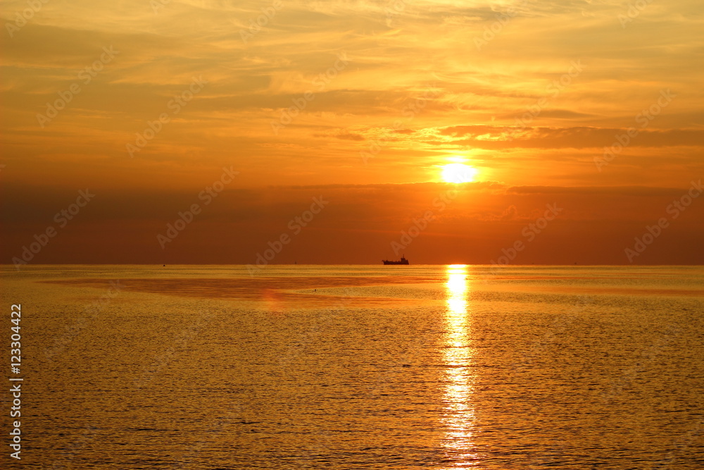 Silhouettes of the ships in the sea at sunrise