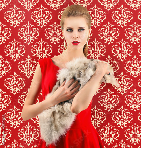 Elegant woman in fur cape o...