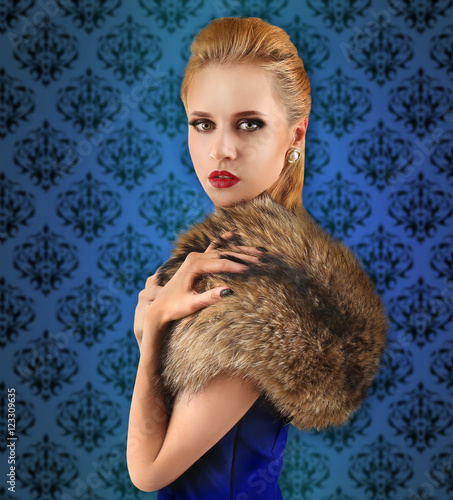 Elegant woman in fur cape o...