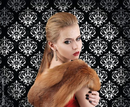 Elegant woman in fur cape o...