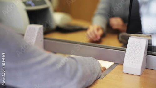 clerk counting money and customer at bank office
