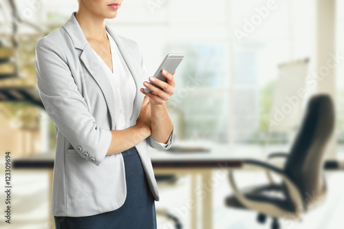 Businesswoman with phone on...