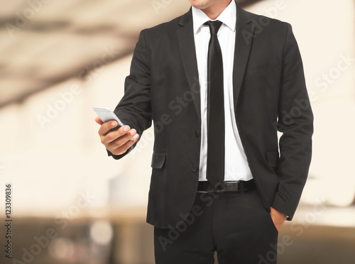 Businessman holding phone i...