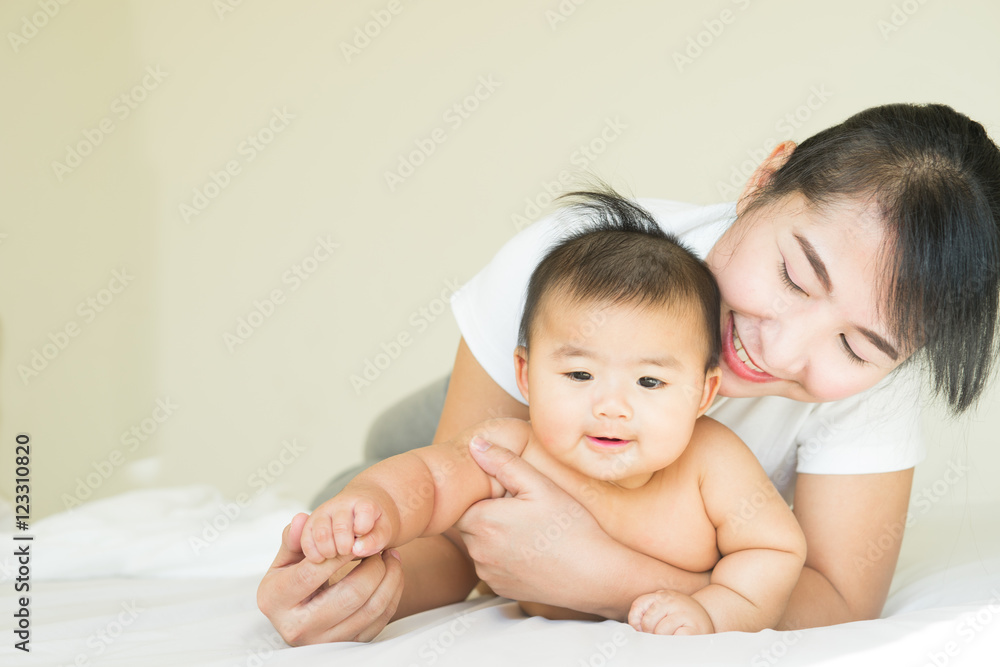 happy family.asian Mother and baby playing and smiling under a b happy family.asian Mother and baby playing and smiling under a b