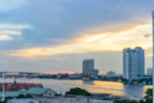 Blurred Cityscape of Bangkok with Chao Phraya river at evening time © bigy9950