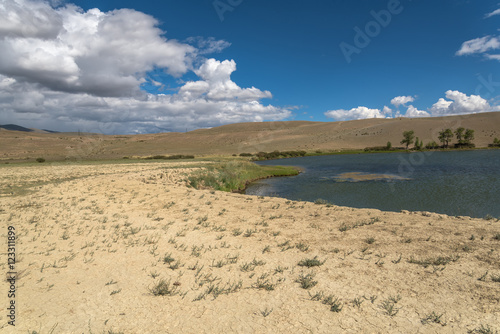 lake steppe sky clouds mountains