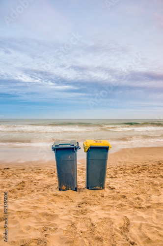 Two trash cans on the beach