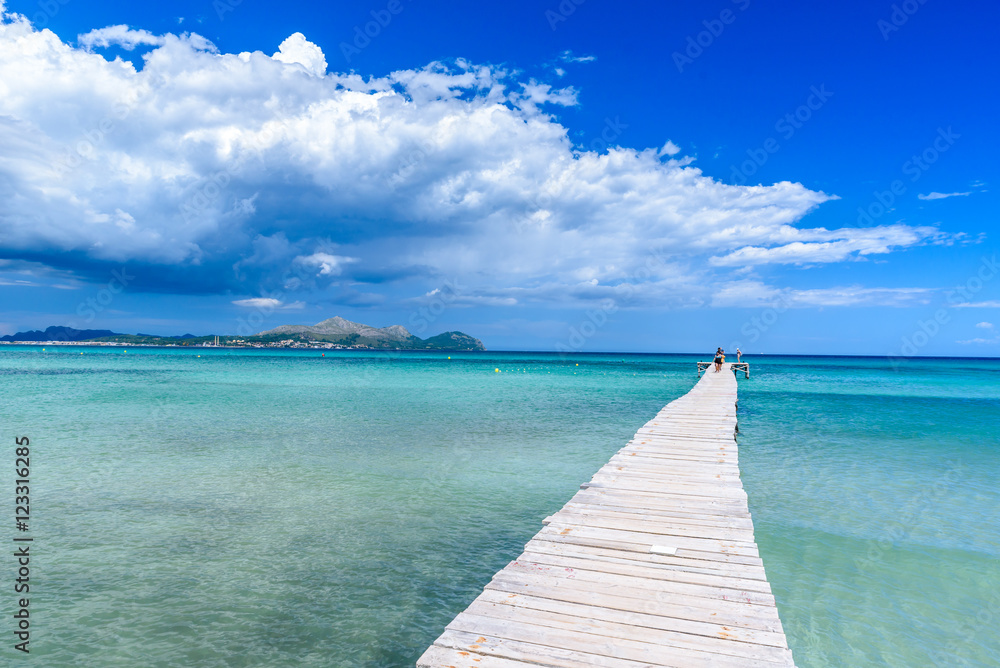 Pier at Playa Muro - beautiful beach on Mallorca, balearic island of spain Pier at Playa Muro - beautiful beach on Mallorca, balearic island of spain