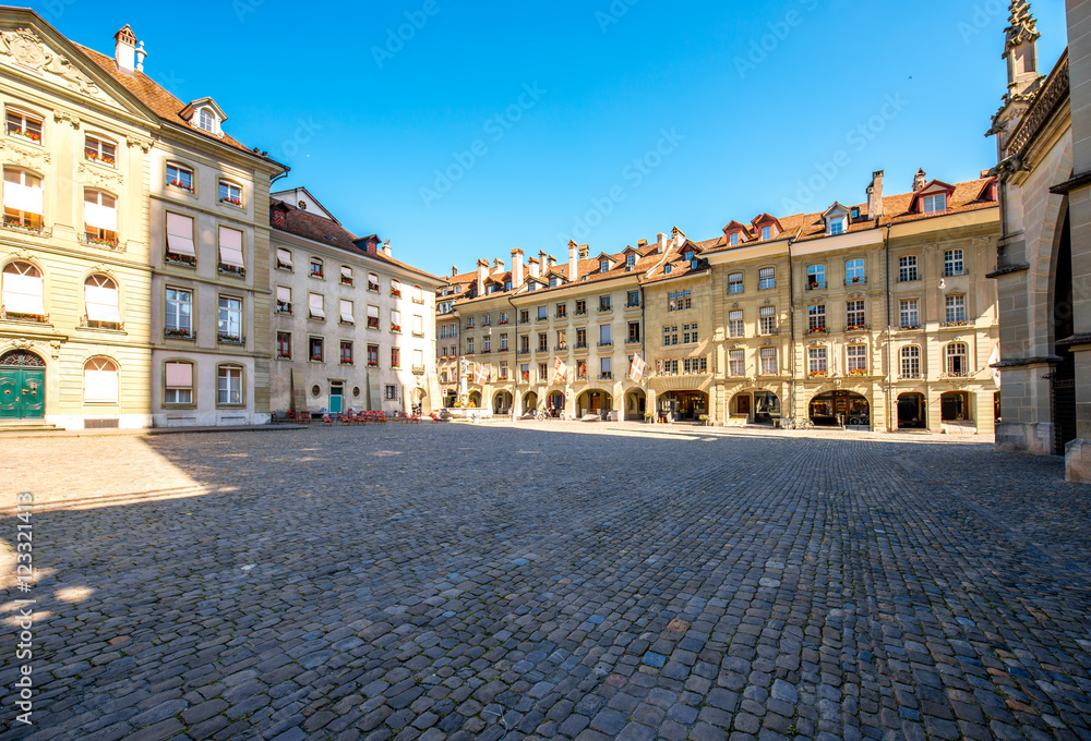 View on the city square with historical buildings near Munster church in the old town of Bern