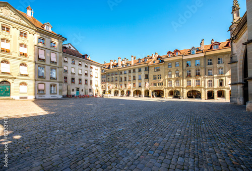 View on the city square with historical buildings near Munster church in the old town of Bern