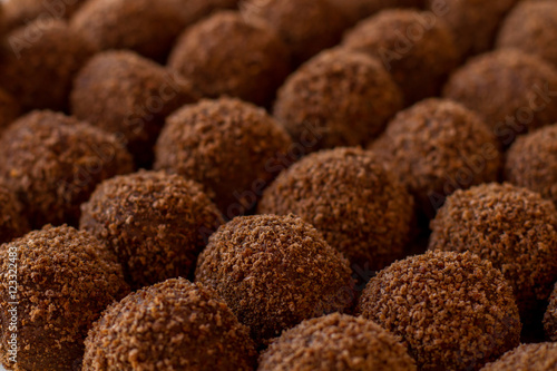 Sweets of brown color. Ball shaped candies. Tasty dessert from russian cuisine. Crumbled cookies and butter,