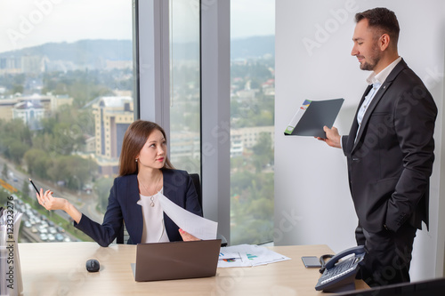 Businessman brought the report to his colleague young Asian girls