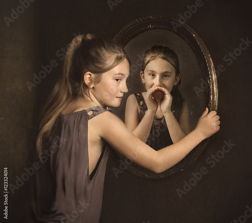 Portrait of a girl with her alter ego whispering to her in a mirror