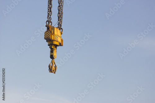 Isolated hook crane over a sky background.