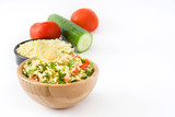 Tabbouleh salad with couscous and vegetables isolated on white background

