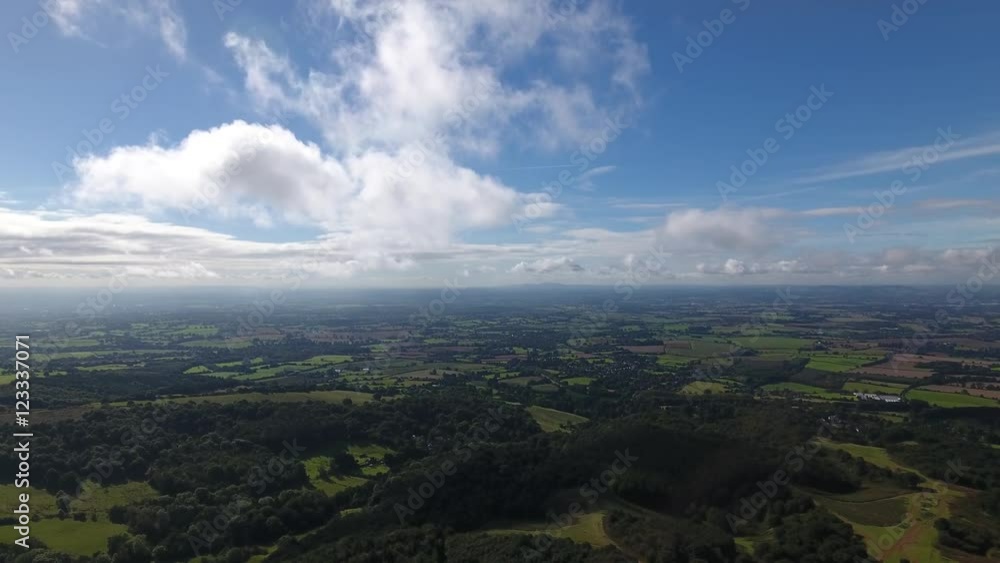 Aerial view flying towards clouds over the english countryside.