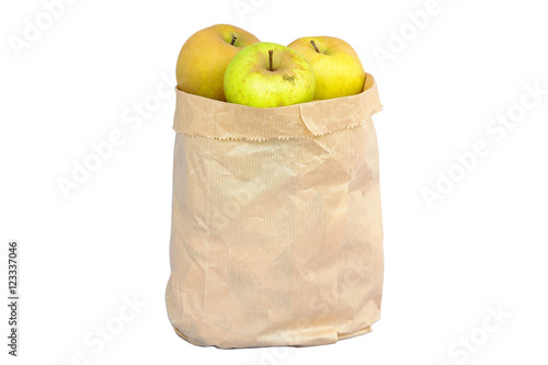 Imperfect looking organic apples with unconventionally raised method, no genetically modified organism techniques, in brown grocery bag