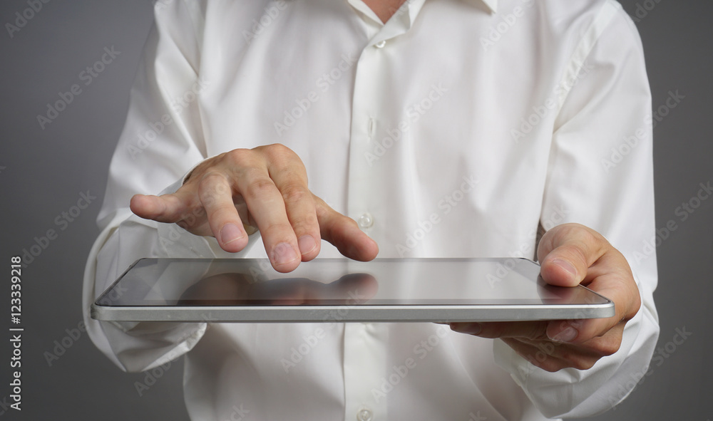 Man in the white shirt works with tablet PC Man in the white shirt works with tablet PC