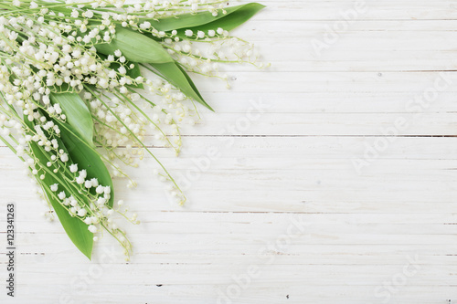 may-lily on wooden background