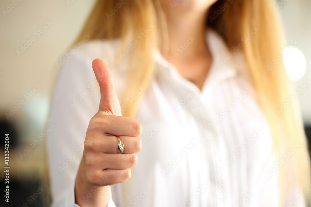 Businesswoman showing OK or approval sign with thumb up Businesswoman showing OK or approval sign with thumb up