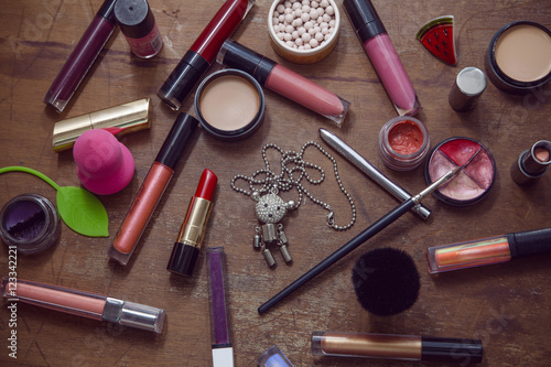 Set with Cosmetics on wood background, necklaces