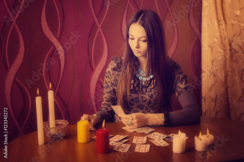 Young woman with divination cards in room